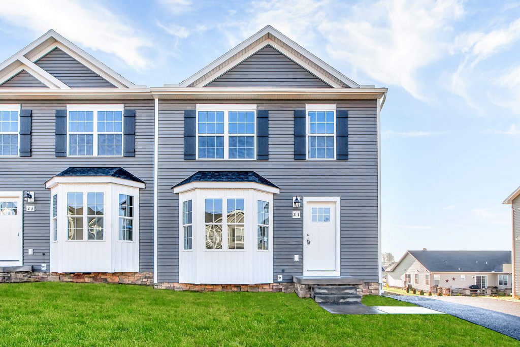 duplex home grey siding white bump outs